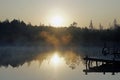 Early in the morning over the lake. Light fog and first rays of sunlight. September. Royalty Free Stock Photo