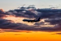 Early morning passenger aircraft flying against the backdrop of a scenic sky. Airplane silhouette Royalty Free Stock Photo