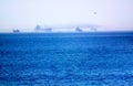 Early morning sea and cargo ship in the distance Royalty Free Stock Photo