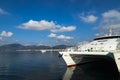 Early in the morning at the seaport. The rising sun illuminat a large white ferry catamaran standing at the pier