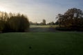 Early morning shadows and dew cover the lawns of Cedar Hill Golf Course as seen from a tee off Royalty Free Stock Photo