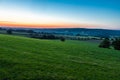 early morning with a sky full of beautiful colors during sunrise in the rolling hills landscape of Limburg Royalty Free Stock Photo