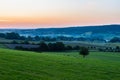 early morning with a sky full of beautiful colors during sunrise in the rolling hills landscape of Limburg Royalty Free Stock Photo