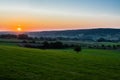 early morning with a sky full of beautiful colors during sunrise in the rolling hills landscape of Limburg Royalty Free Stock Photo