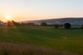 early morning with a sky full of beautiful colors during sunrise in the rolling hills landscape of Limburg Royalty Free Stock Photo