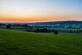 early morning with a sky full of beautiful colors during sunrise in the rolling hills landscape of Limburg Royalty Free Stock Photo