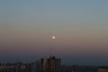 Early morning sky over the city and the moon