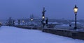 Early Morning snowy Prague Lesser Town with gothic Castle, Bridge Tower and St. Nicholas' Cathedral from Charles Bridge Royalty Free Stock Photo