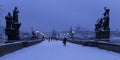 Early Morning snowy Prague Lesser Town with gothic Castle, Bridge Tower and St. Nicholas' Cathedral from Charles Bridge Royalty Free Stock Photo