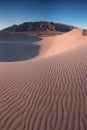 Early Morning Sunlight Over Sand Dunes And Mountains At Mesquite flat dunes, Death Valley National Park, California USA Royalty Free Stock Photo