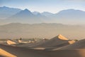 Early Morning Sunlight Over Sand Dunes And Mountains At Mesquite flat dunes, Death Valley National Park, California USA Stovepipe Royalty Free Stock Photo