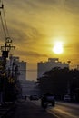 The early morning sunlight shining on buildings and the cars on the road at Bangyai City of Nonthaburi in Thailand. December 25