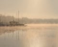 Early morning sunrise, boating on the lake in a huge fog Royalty Free Stock Photo