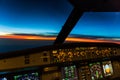 Early morning sunrise - captains view in the flight deck of a modern airliner airplane Royalty Free Stock Photo