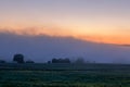 Early morning sunrise landscape with bushes in fog near river at summer Royalty Free Stock Photo