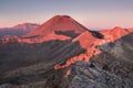 Early morning sunrise, landscape scenery of blue lake, wild mountains and huge volcano, autumn colours and golden sun rays.