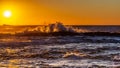 Sunrise over the Ocean with Crashing Waves