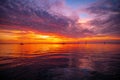 Early morning, sunrise over sea. Ocean sunset on sea water with a colorful vivid sunset sky and silhouettes of sailboat Royalty Free Stock Photo