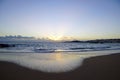 Early morning before sunrise. Surf waves and beach. Black rocks. Royalty Free Stock Photo