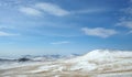 Early morning sunrise in Tazheran steppes. Snow-covered hills are colored in shades of ultra-violet. Royalty Free Stock Photo