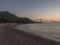 Early Morning Sunrise view of sand beach Spiaggia di Santa Maria Navarrese, sea with green forest and limestone rock of Royalty Free Stock Photo