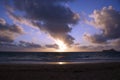 Early Morning Sunrise on Waimanalo Beach over ocean bursting through the clouds Royalty Free Stock Photo