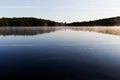 Early morning at Swan Lake in Maine with fog on the surface on a calm late spring day Royalty Free Stock Photo