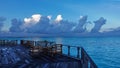 Early morning. On the terrace above the aquamarine ocean, there are tables and chairs Royalty Free Stock Photo