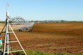 A center pivot agricultural sprinkler system in a farm field Royalty Free Stock Photo