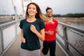 Early morning workout. Happy couple running across the bridge Royalty Free Stock Photo