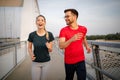 Early morning workout. Happy couple running across the bridge Royalty Free Stock Photo