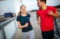 Early morning workout. Happy couple running across the bridge Royalty Free Stock Photo