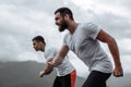 Early morning workout, sportive men running in mountains living healthy lifestyle Royalty Free Stock Photo