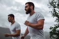 Early morning workout, sportive men running in mountains living healthy lifestyle Royalty Free Stock Photo