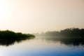 Early morning at yamuna ghat with golden sun, fog and blue water