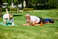 Early morning yoga. Mature couple, sportive man and woman training outdoors in park on warm summer day. Royalty Free Stock Photo