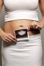 Early pregnancy, ultrasound result in hands Royalty Free Stock Photo