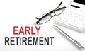 EARLY RETIREMENT Concept. Calculator,pen and glasses on white background Royalty Free Stock Photo