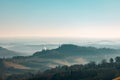 Early smoggy morning in San Gimignano, Italy. Beautiful vineyards countryside landscape on sunrise. Amazing Tuscany