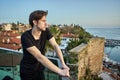 Early spring in Antalya, young white man looks at sea from observation deck above old city. Royalty Free Stock Photo