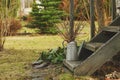 Early spring garden view. Old rustic stairs with twigs bouquet