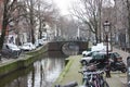 Early spring scene in Amsterdam city. Tours by boat on the famous Dutch canals. Cityscape with canal houses in Holland, Royalty Free Stock Photo