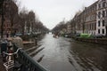 Early spring scene in Amsterdam city. Tours by boat on the famous Dutch canals. Cityscape with canal houses in Holland, Royalty Free Stock Photo