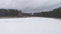 In early spring, there is still ice on the reservoir, covered with snow. On the banks where the forest stands the snow has already Royalty Free Stock Photo