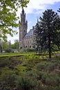 Peace Palace behind a woodland, Vredespaleis, under a pure gradient blue sky, seat of the ICJ, International Court of Justice, Royalty Free Stock Photo