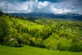 Early summer scenery with snowy mountains and green hills, Romania Royalty Free Stock Photo