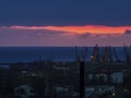 Early sunrise, clouds, port, city and the sea Royalty Free Stock Photo
