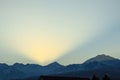 Early sunrise in the Trans-Ili Alatau mountains, the sun's rays pass over the mountains in the early winter morning