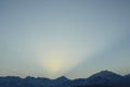 Early sunrise in the Trans-Ili Alatau mountains, the sun& x27;s rays pass over the mountains in the early winter morning