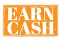 EARN CASH, words on orange grungy stamp sign Royalty Free Stock Photo